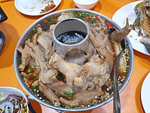 Thai food style,Top view of Chicken Feet Spicy Soup in hot pot