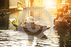 Thai fruit seller sailing wooden boat in thailand tradition floating market photo