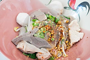 Thai Fusion Food, dry noodle with pork in ceramic bowl