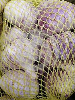 Thai Garlic Stopper in a yellow net bag