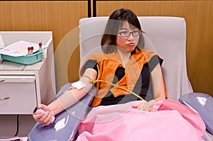 Thai girl donating blood in red cross institution