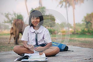 Thai girl sitting on bamboo mat