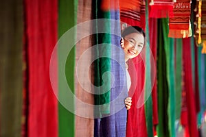 Thai girl in traditional lanna costume travel in  lamduan woven cloth