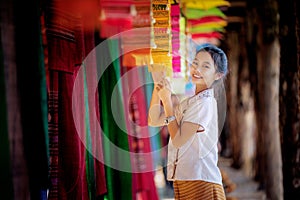 Thai girl in traditional lanna costume travel in  lamduan woven cloth