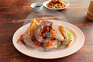 Thai grilled chicken on wooden table