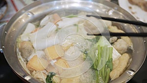 Thai hot pot style suki full of fish ball, vegetable, meat, pork slide.