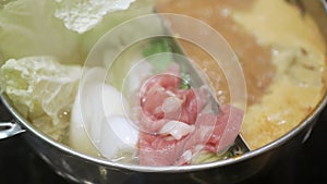 Thai hot pot style suki full of fish ball, vegetable, meat, pork slide.