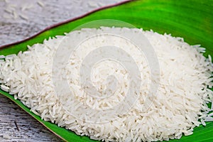 Thai jasmine rice on green leaf top view