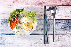 Thai jasmine rice topped soft boil eggs and fried herb.