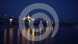 Thai Laos boarder transportation bridge over mekong river beautiful refliection at night view with half light lit during pandemic