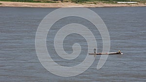 Thai and laos people riding long tail boat for catch fishing in mekong river