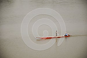 Thai and laos people riding long tail boat for catch fishing in Mekong river