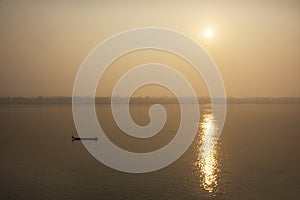 Thai and laos people riding long tail boat for catch fishing and reflection light surface water of Mekhong River and lighting of