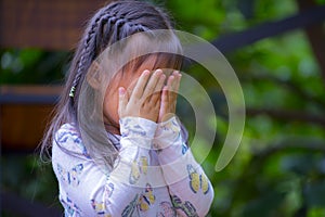 Thai Little girl praying, crying, hopelessness, despair or Prayer photo