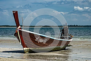 Thai Longboat beached on the sea