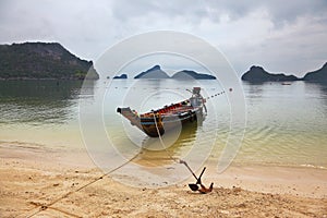 Thai Longtail boat moored on a sandy beach