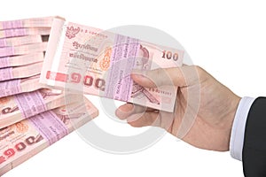 Thai Male hand handling pack of 100 banknotes of 100 baht with pile of pack of 100 banknotes background
