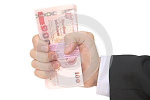 Thai Male hand handling pack of 100 banknotes