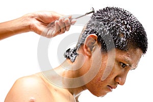 Thai man gets his head shaved.