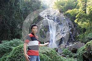 Thai man with Mae Tia Waterfall, Obluang National Park, Chiangmai