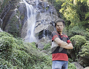 Thai man with Mae Tia Waterfall, Obluang National Park, Chiangmai
