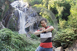 Thai man with Mae Tia Waterfall, Obluang National Park, Chiangmai