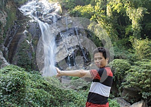 Thai man with Mae Tia Waterfall, Obluang National Park, Chiangmai