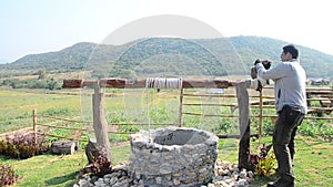 Thai man with water-well at Viewpoint in winter season at Ban Kha