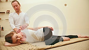 Thai massage - seductive female - stretch the muscles of body