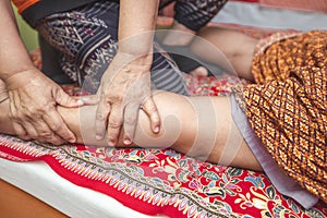 Thai massage and spa for healing and relaxation. Young woman getting traditional thai stretching massage