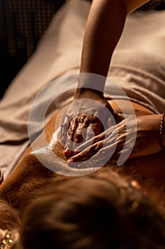 Thai massage at the spa. the masseur& x27;s hands are close-up doing an oil massage on a woman& x27;s body
