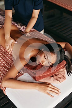 Thai Massage. Woman Having Relaxation Back Massage At Spa Salon