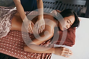 Thai Massage. Woman Having Relaxation Back Massage At Spa Salon