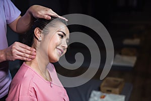 Thai massaging head and neck in spa