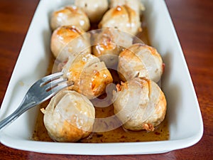 Thai meatballs on spicy and sweet sauce.