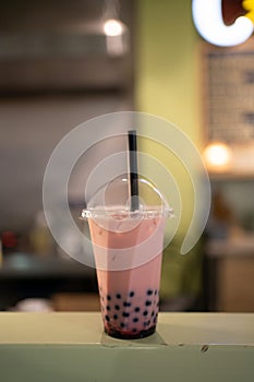 Thai milk tea with bubbles in cafe restaurant, selective focus