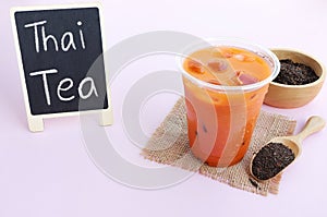 Thai Milk Tea or Milk ice tea, A glass of ice milk tea on pink background.