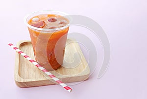 Thai Milk Tea or Milk ice tea, A glass of ice milk tea on pink background.