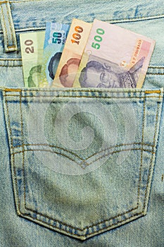 Thai money in a blue jeans pocket