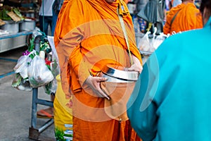 Thai monk ask for alms for buddhist to make merit