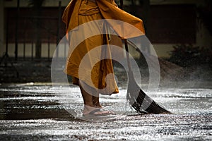 Thai monk daily cleaning in buddist temple