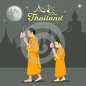 Thai Monks and novice in Buddhist light waving rite photo
