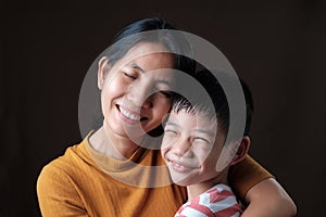 Thai mother and son hugging each other