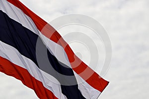 Thai national flag waves on the sky