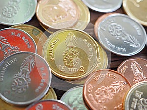 Thai new coin in King Rama 10 on wooden board with concept of finance, banking