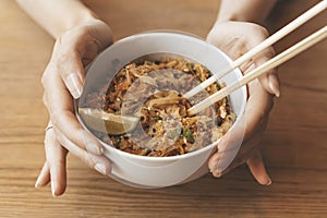 Thai noodle Pad Thai bowl background. Traditional rice noodles with shrimp and seafood. Asian food concept.