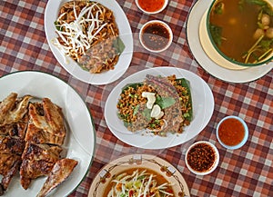 Thai northeastern traditional food, grilled chicken, stir-fried noodle, papaya salad, sour spicy duck