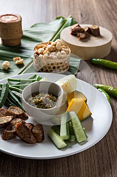 Thai northern food. Nam Prik Num Northern Thai Green Chilli Dip, Streaky pork with crispy crackling, Sai aua spicy sausge and