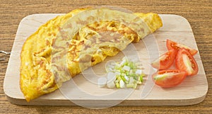 Thai Omelette with Tomatoes and Scallion on Cutting Board