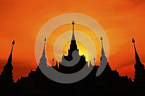 Thai pagoda at sunset, silhouette of pagoda